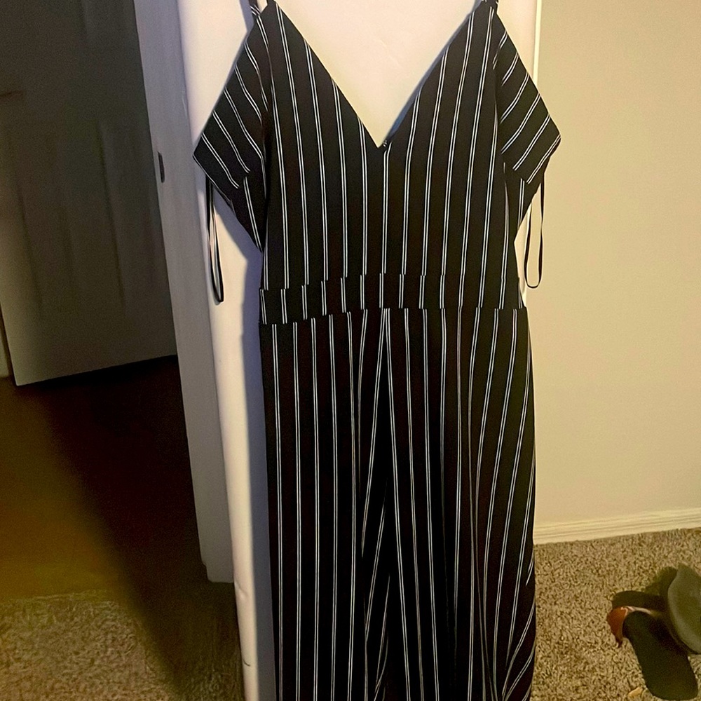 Black pin stripe pantsuit. Tank top.